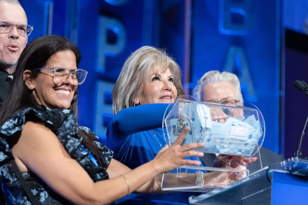 Lyn Ferriero feels for the winning ticket of the Blue Hope Bash's Porsche car raffle.