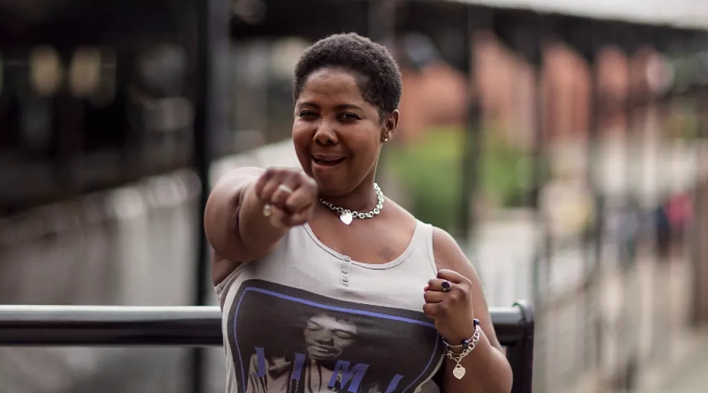 Angela Caraway is pictured punching the air in a gesture of strength