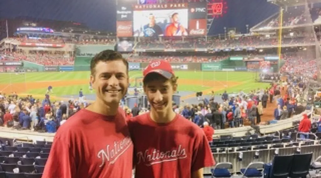 Dylan and his father at a baseball game. 