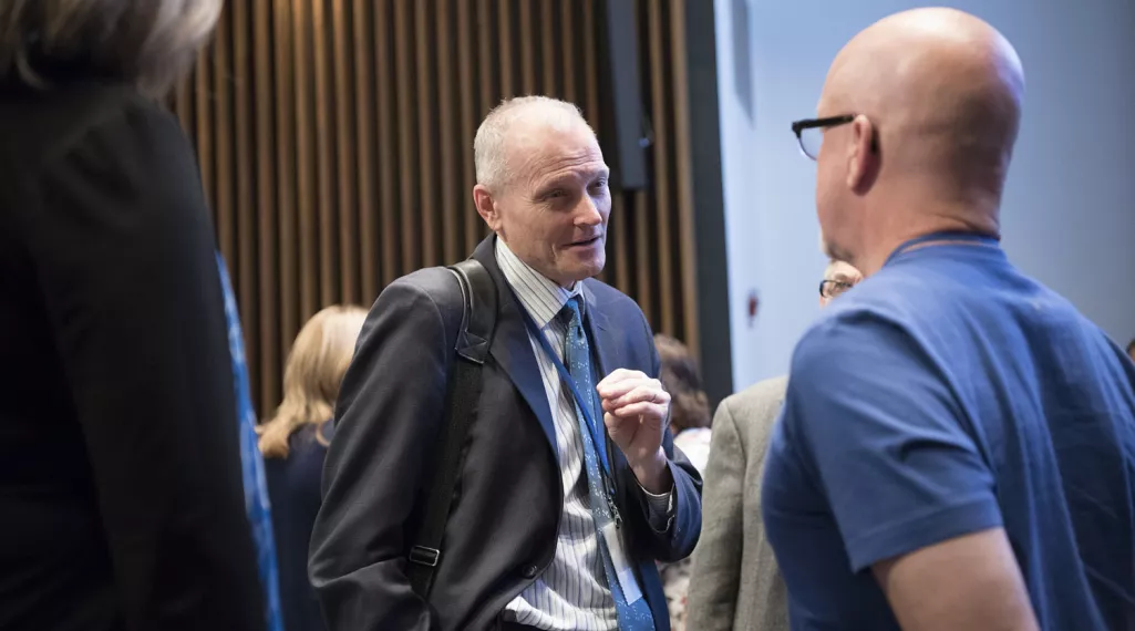 Dr. John Marshall discusses colorectal cancer with a Colorectal Cancer Alliance event attendee.