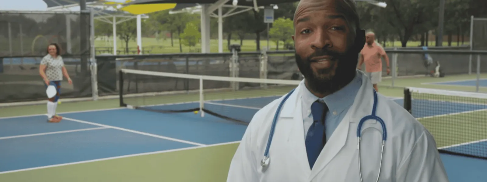 A doctor on a tennis court describes the preventable nature of colorectal cancer through routine screening