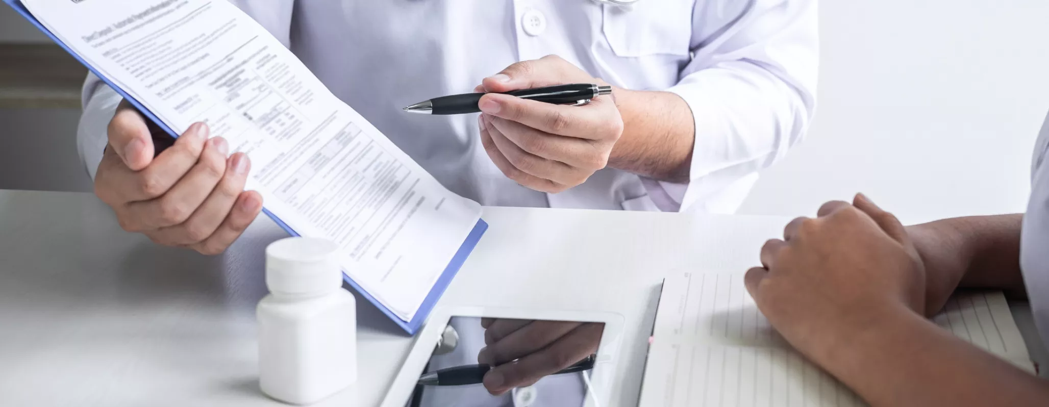 A doctor explains a form to a patient 