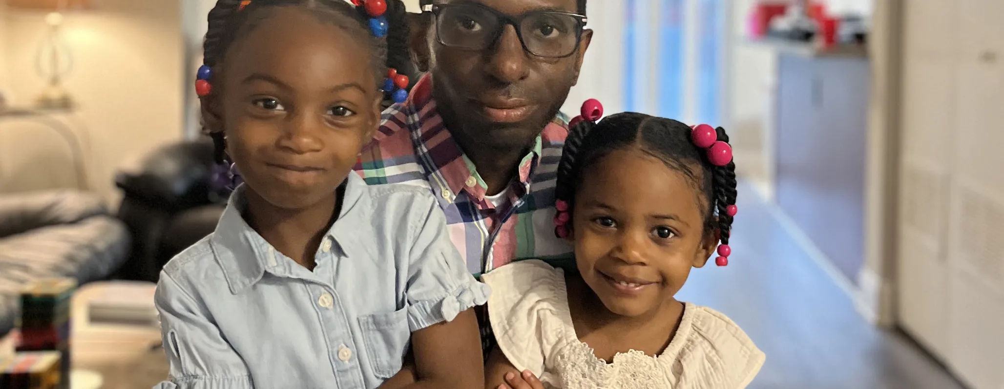 Man with two girls hugging