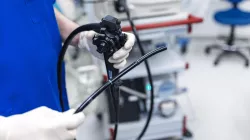 A medical professional holds a colonoscope, the instrument used for colonoscopy colorectal cancer screening. 