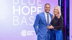 Craig Melvin and Lindsay Czarniak stand together smiling at the Colorectal Cancer Alliance’s 2025 Blue Hope Bash, with the event logo displayed behind them.