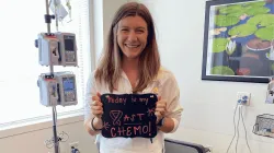 Kat in a hospital with a sign that says last chemo