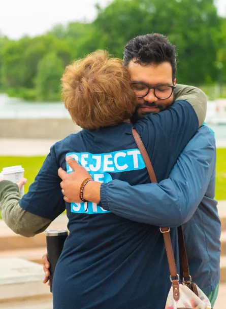 man and woman hugging