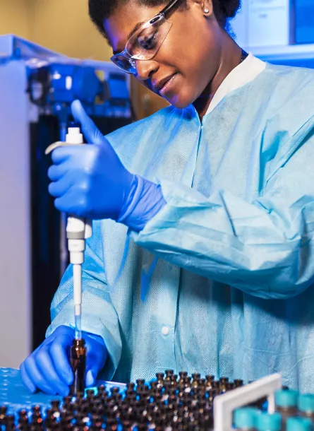 black female scientist fills vials