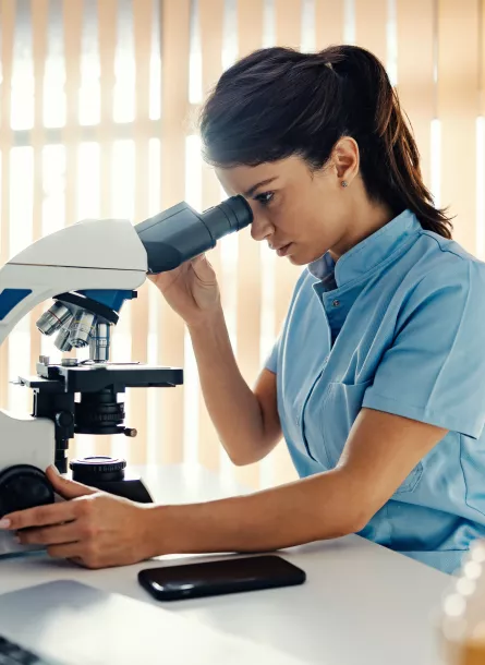 female researcher with a microscope