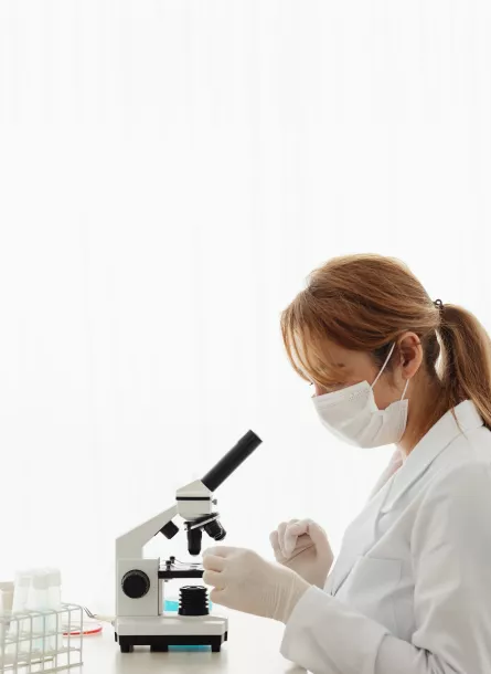 profile of female scientist using microscope