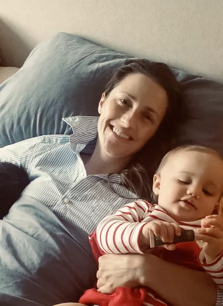 Natalie with family resting in bed