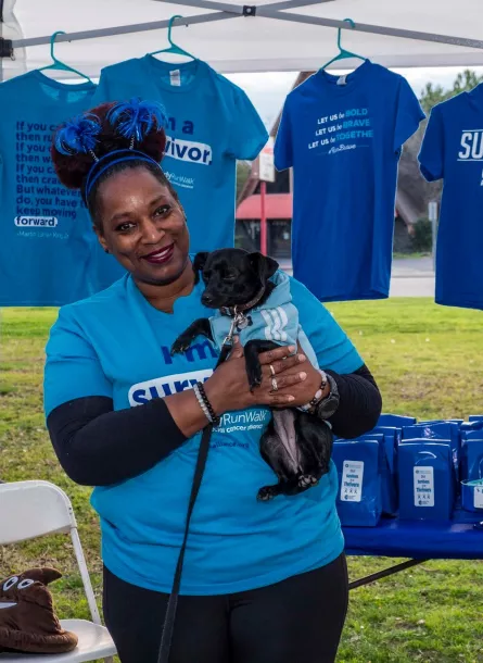 Volunteer at walk with dog at booth