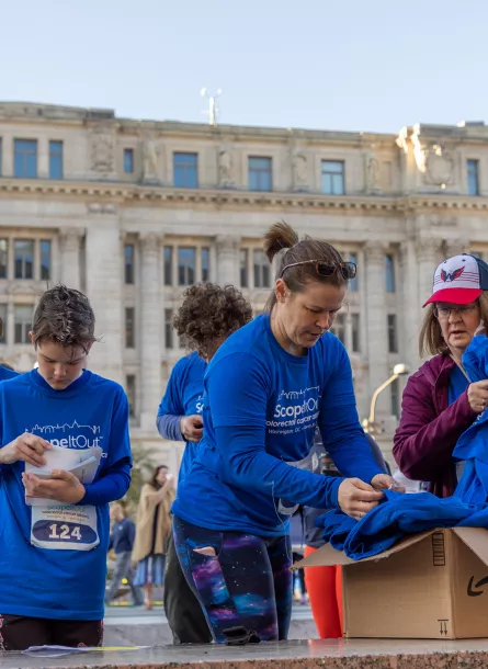 People retrieving blue T-shirts before the walk