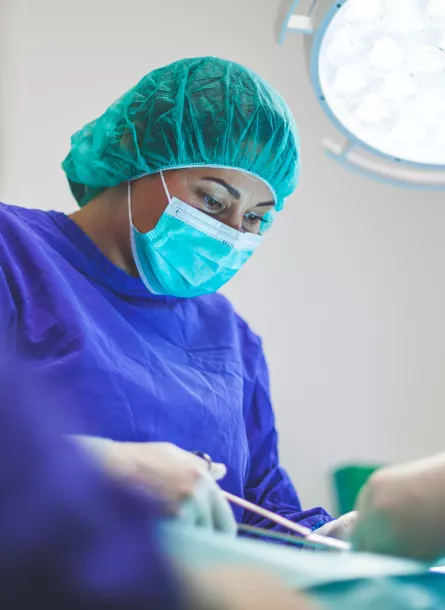 Woman performing surgery