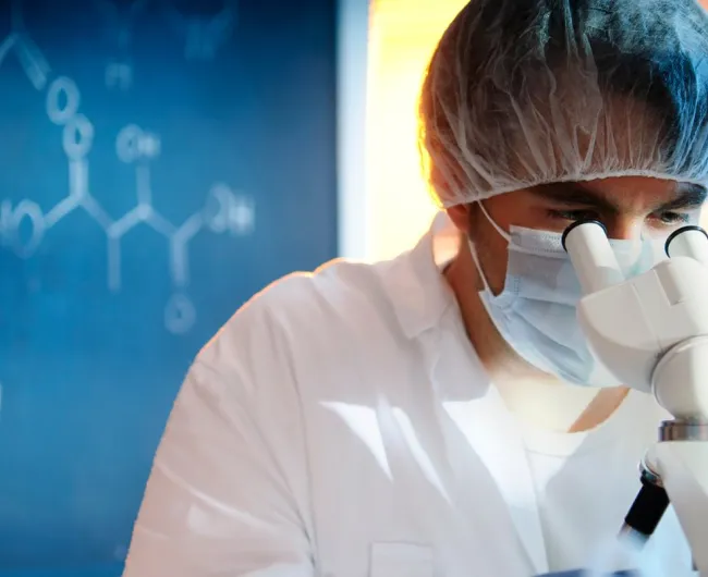 researcher_looks_through_microscope