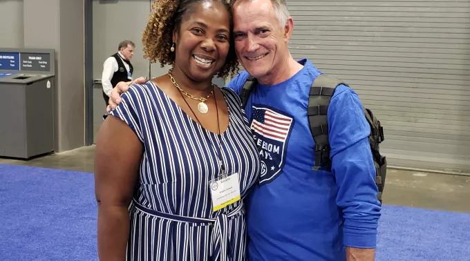 Black woman and man smiling at Allycon