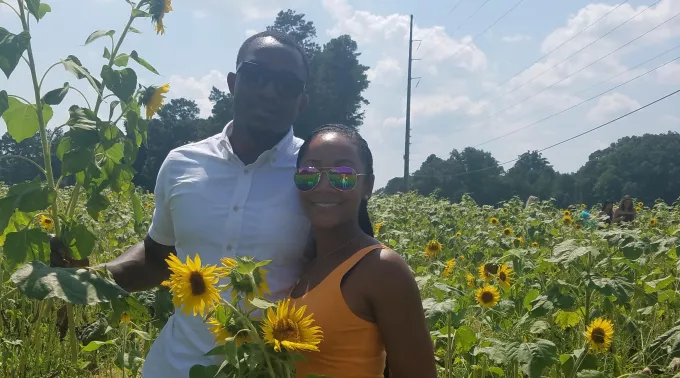 couple posing in sunflower field