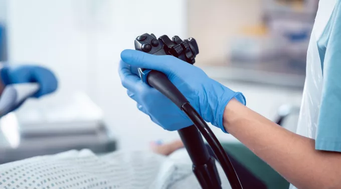 doctor holding scope with patient