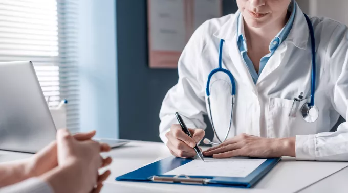 female doctor with blue clipboard