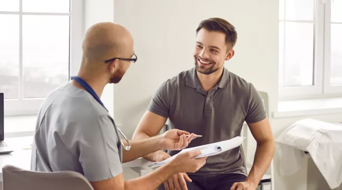 man with doctor holing papers