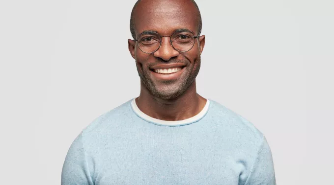 man smiling in blue sweater