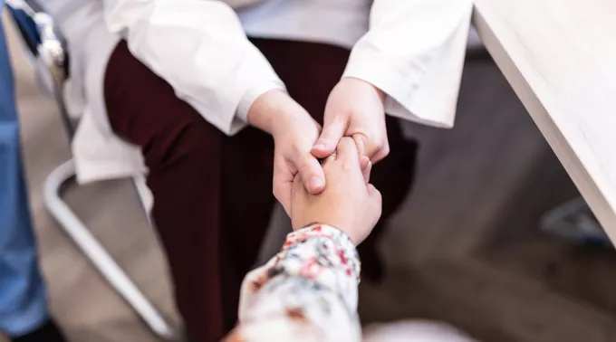 provider holds a patient's hand