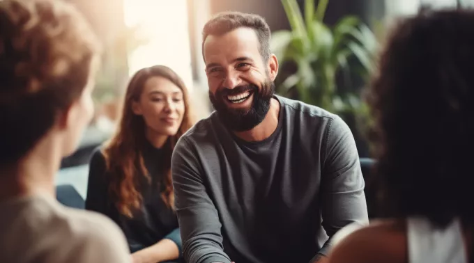 young bearded man laughing 