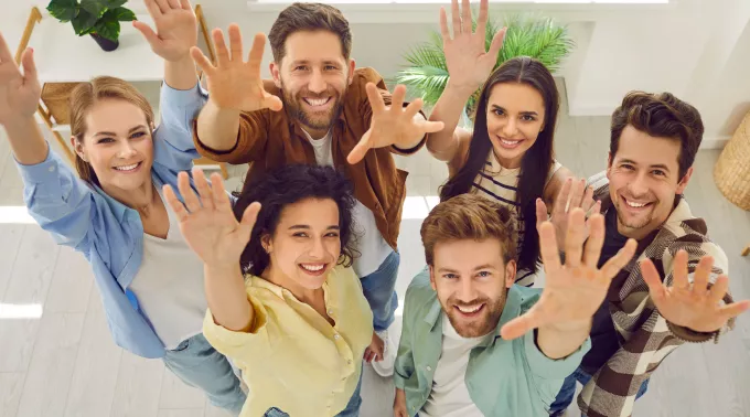 young group with hands up