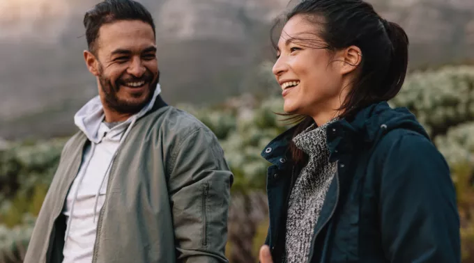 younger couple walking in park