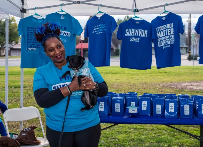 Volunteer at walk with dog at booth