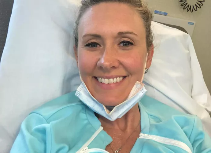 woman smiling in a hospital bed