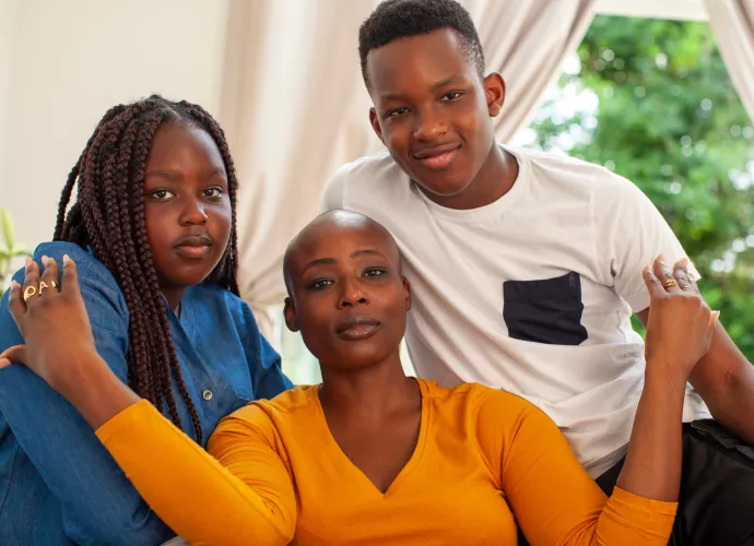 Woman with two kids looking at camera