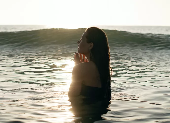 young woman standing in ocean