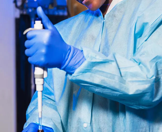 black female scientist fills vials