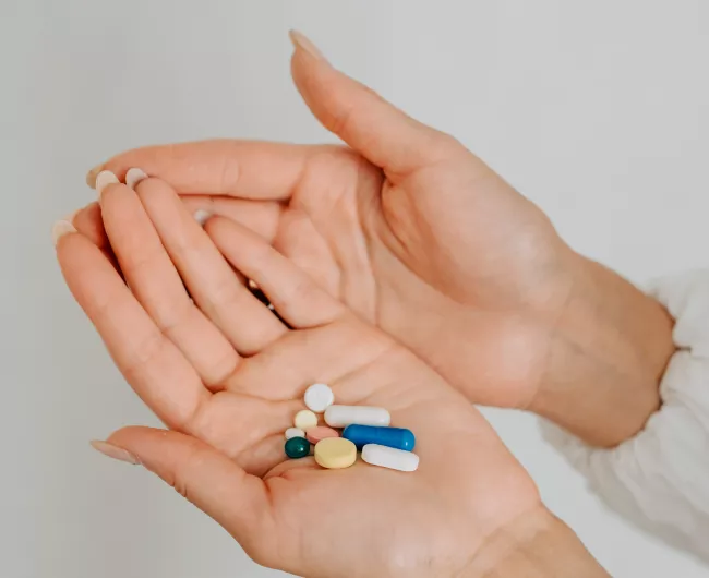 colorful pills in a woman's hands