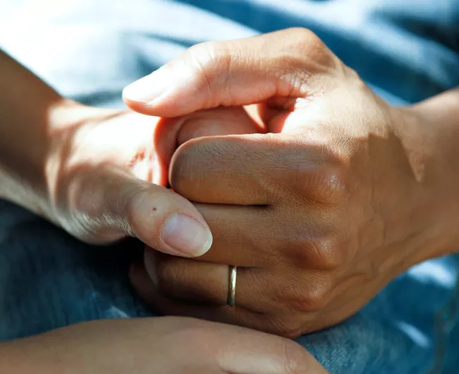 a couple holding hands while seated