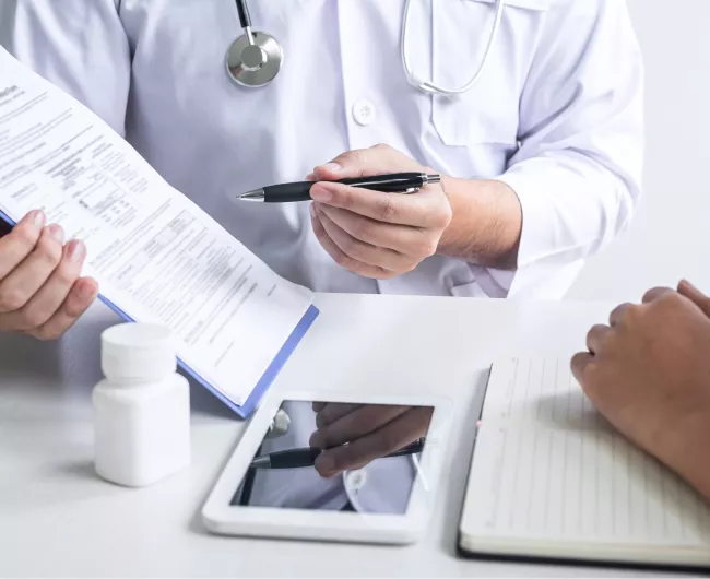 A doctor explains a form to a patient 