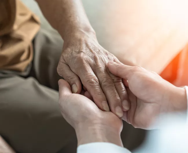 doctor holding woman's hand