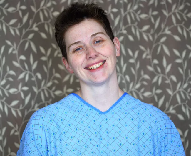 female patient smiling in a hospital gown