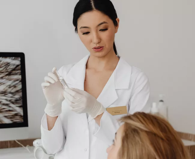 female doctor explaining treatment to female patient
