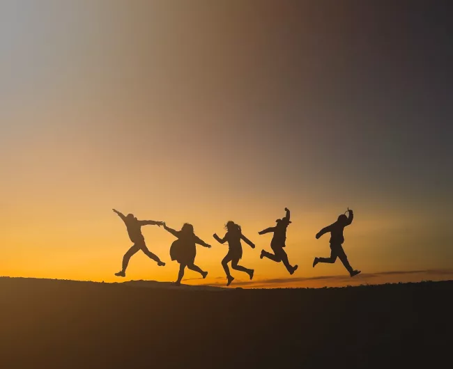 group hiking at sunset