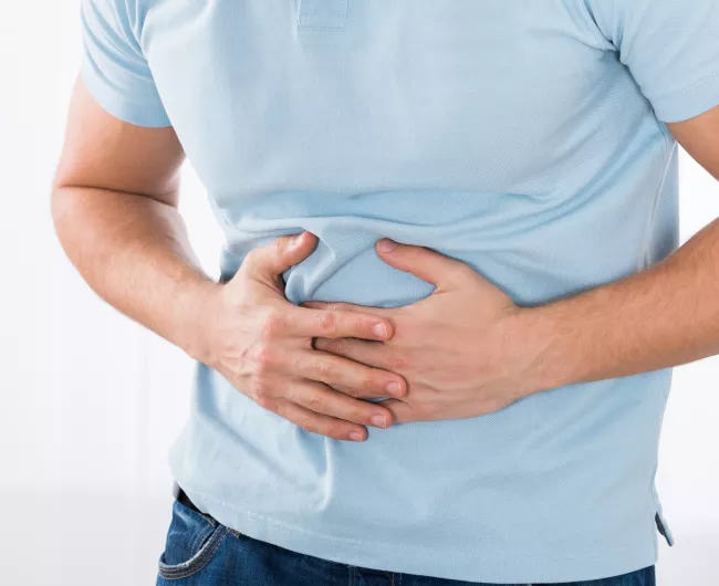 man holding stomach in pain