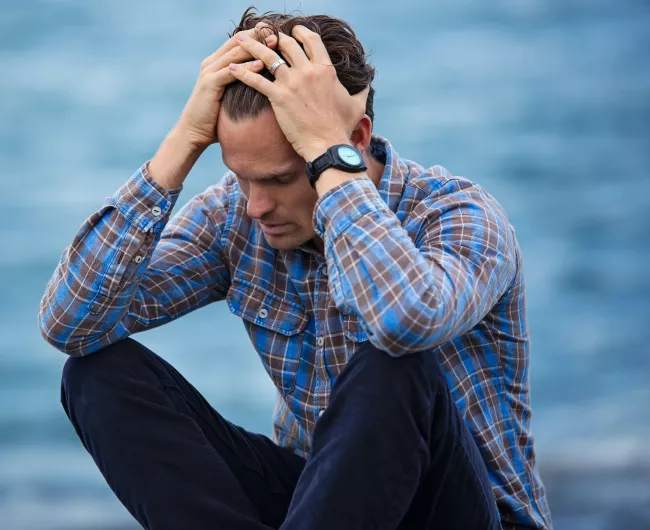 man stressing by water