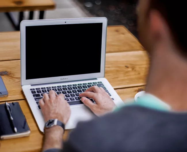 Man using laptop at desk