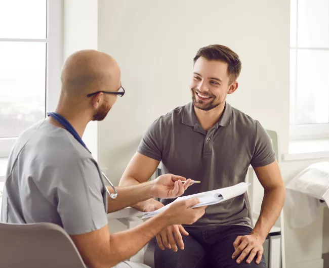 man with doctor holing papers