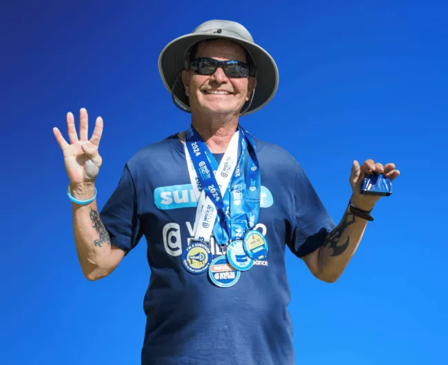 a colorectal cancer survivor gestures in happy manner