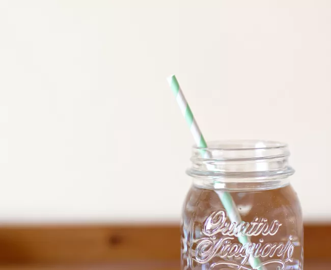 glass jar with water and straw