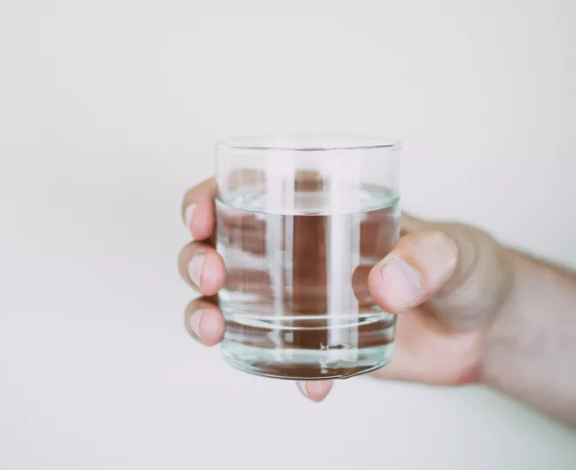 hand holding glass of water