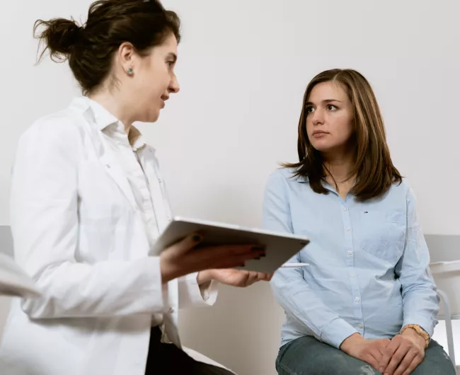 female doctor speaking to female patient