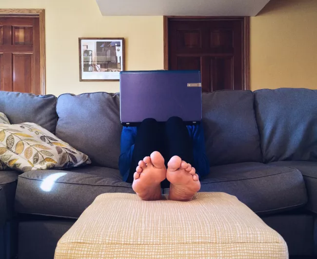 person sitting on couch with feet up